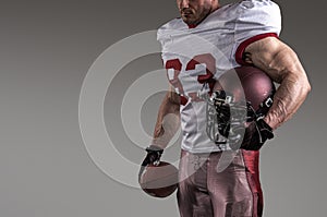 American football sportsman player on stadium with lights on background