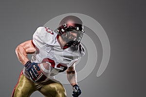 American football sportsman player on stadium with lights on background