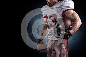 American football sportsman player on stadium with lights on background