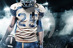 American football sportsman player on stadium with lights on background