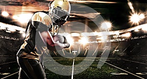 American football sportsman player on stadium running in action. Sport wallpaper with copyspace.