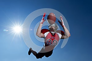 American Football Wide Receiver dives to make the catch