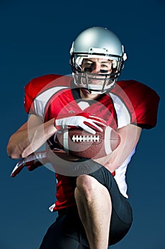 American Footballer Portrait looks directly into camera.