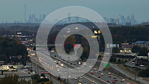 American freeway with fast driving cars and trucks and highrise skyscrapers of Atlanta city in Georgia state. View from