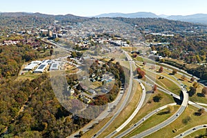 American freeway intersection in Asheville, North Carolina with fast driving cars and trucks in autumnal season. View