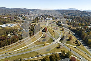 American freeway intersection in Asheville, North Carolina with fast driving cars and trucks in autumnal season. View