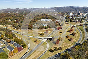 American freeway intersection in Asheville, North Carolina with fast driving cars and trucks in autumnal season. View