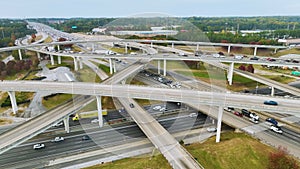 American freeway intersection with fast driving cars and trucks. View from above of USA transportation infrastructure