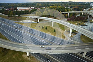 American freeway intersection with fast driving cars and trucks. View from above of USA transportation infrastructure