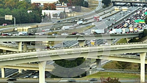 American freeway intersection with fast driving cars and trucks. View from above of USA transportation infrastructure