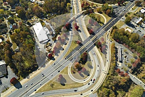 American freeway intersection with fast driving cars and trucks. View from above of USA transportation infrastructure