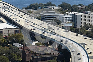 American freeway intersection with fast driving cars and trucks. View from above of USA transportation infrastructure