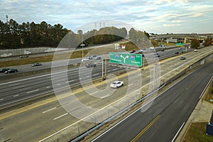 American freeway intersection with fast driving cars and trucks. View from above of USA transportation infrastructure