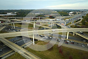 American freeway intersection with fast driving cars and trucks. View from above of USA transportation infrastructure