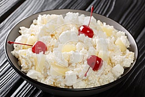American Glorified Rice Salad topped with maraschino cherries close-up in a plate. Horizontal