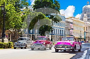 American gray, pink and purple 1953 convertible vintage car on the main street Jose Marti in the old town from Havana City Cuba -