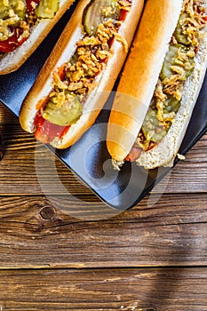 American hot dog with pickles,onions, ketchup and mustard