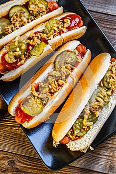 American hot dog with pickles,onions, ketchup and mustard