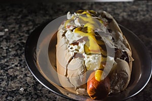 american hot dog with sausage, mustard, pickle and barbecue sauce, selective focus and copy space