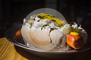 american hot dog with sausage, mustard, pickle and barbecue sauce, selective focus and copy space