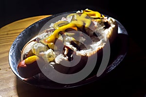 american hot dog with sausage, mustard, pickle and barbecue sauce, selective focus and copy space