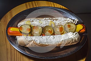 american hot dog with sausage, mustard, pickle and barbecue sauce, selective focus and copy space