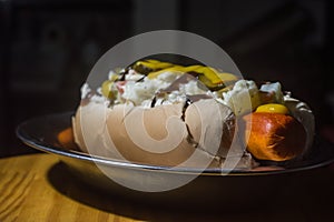 american hot dog with sausage, mustard, pickle and barbecue sauce, selective focus and copy space