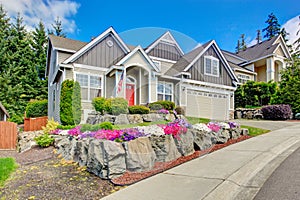 American house with beautiful landscape and vivid flowers