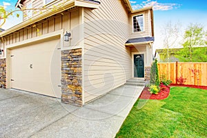 American house exterior with beige trim, garage with concrete driveway