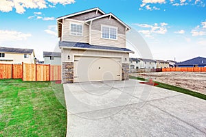 American house exterior with beige trim, garage with concrete driveway