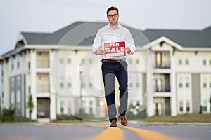 American house seller, real estate agents hold sign for sale. Housing estates in the project, buying and selling housing