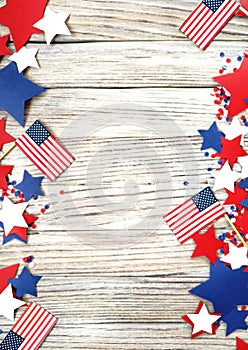 American independence Day, celebration, patriotism and holidays concept - flags and stars on the 4th of July party on top on woode