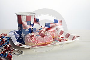 American independence day, celebration, patriotism and holidays concept. Sweet donut with candies in disposable