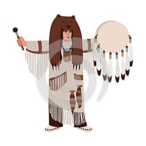 American Indian wearing bearskin and ethnic clothes beating his drum and calling spirits. Shaman priest or medicine man
