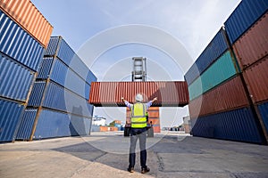 American man Foreman control loading containers box to truck for logistics export  of International global shipping