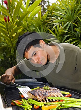 American man grilling rack of lamb