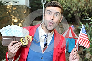 American man holding golden dollar sign necklace