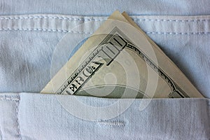 American money in the back pocket of blue jeans. Close-up of 100 dollars banknote.