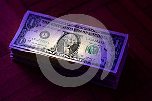 American one dollar bills pile on wooden table