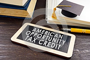 American Opportunity Tax Credit AOTC on plate and graduation cap.
