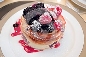 American pancakes with fresh berries and fruit.