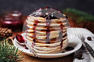 American pancakes or fritters served with strawberry and blueberry jam, delicious dessert for breakfast in winter