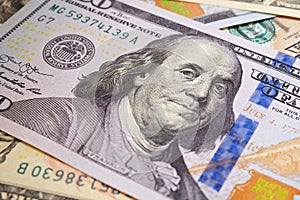 American paper money. A $100 bill with focus on eyes of Benjamin Franklin. US banknotes close-up. Savings economy and the USA