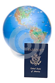 American passport in front of world globe, over white