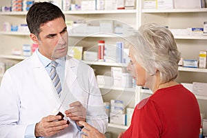 American pharmacist with senior woman in pharmacy