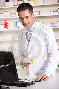 American pharmacist working on computer