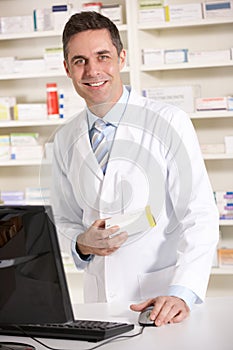 American pharmacist working on computer