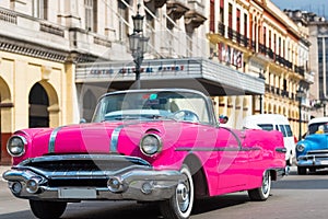 American pink convertible Pontiac classic car drive with tourists through Havana Cuba - Serie Cuba Reportage