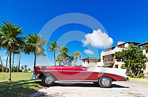 American red 1956 convertible vintage car parked under blue sky in Varadero Cuba - Serie Cuba