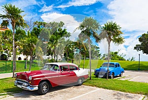 American red brown 1954 vintage cars parked under blue sky near the beach in Havana Cuba -